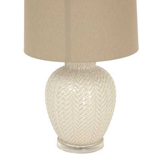 Decorative lamp with woven design on a white background