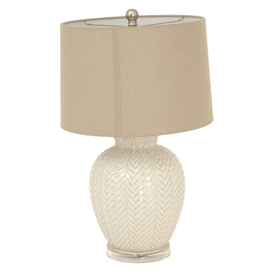 Table lamp with woven design base and beige shade on a white background
