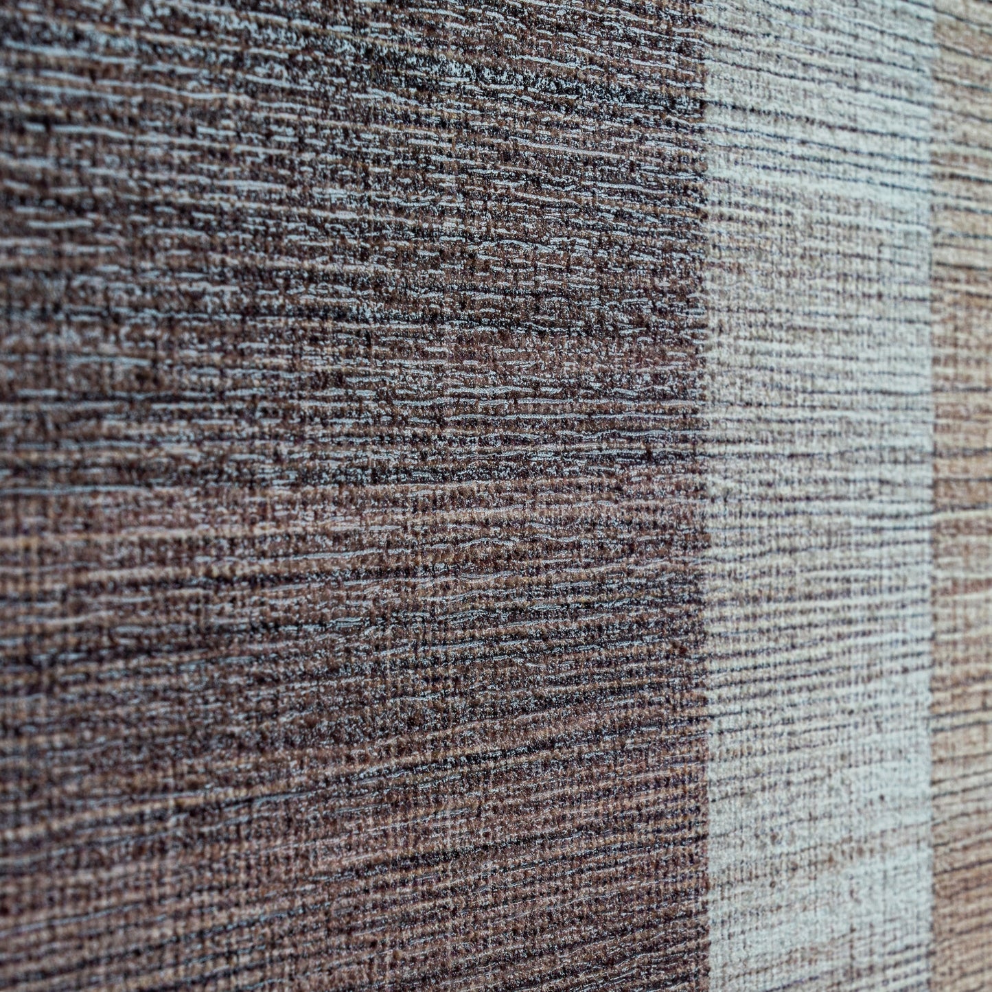 Close-up of a textured fabric with brown and beige colors