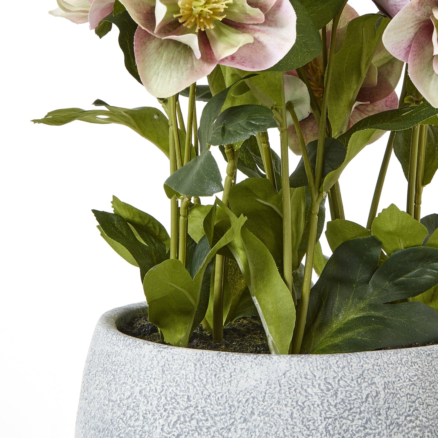 Artificial plant with pink flowers and green leaves in a textured pot on a white background