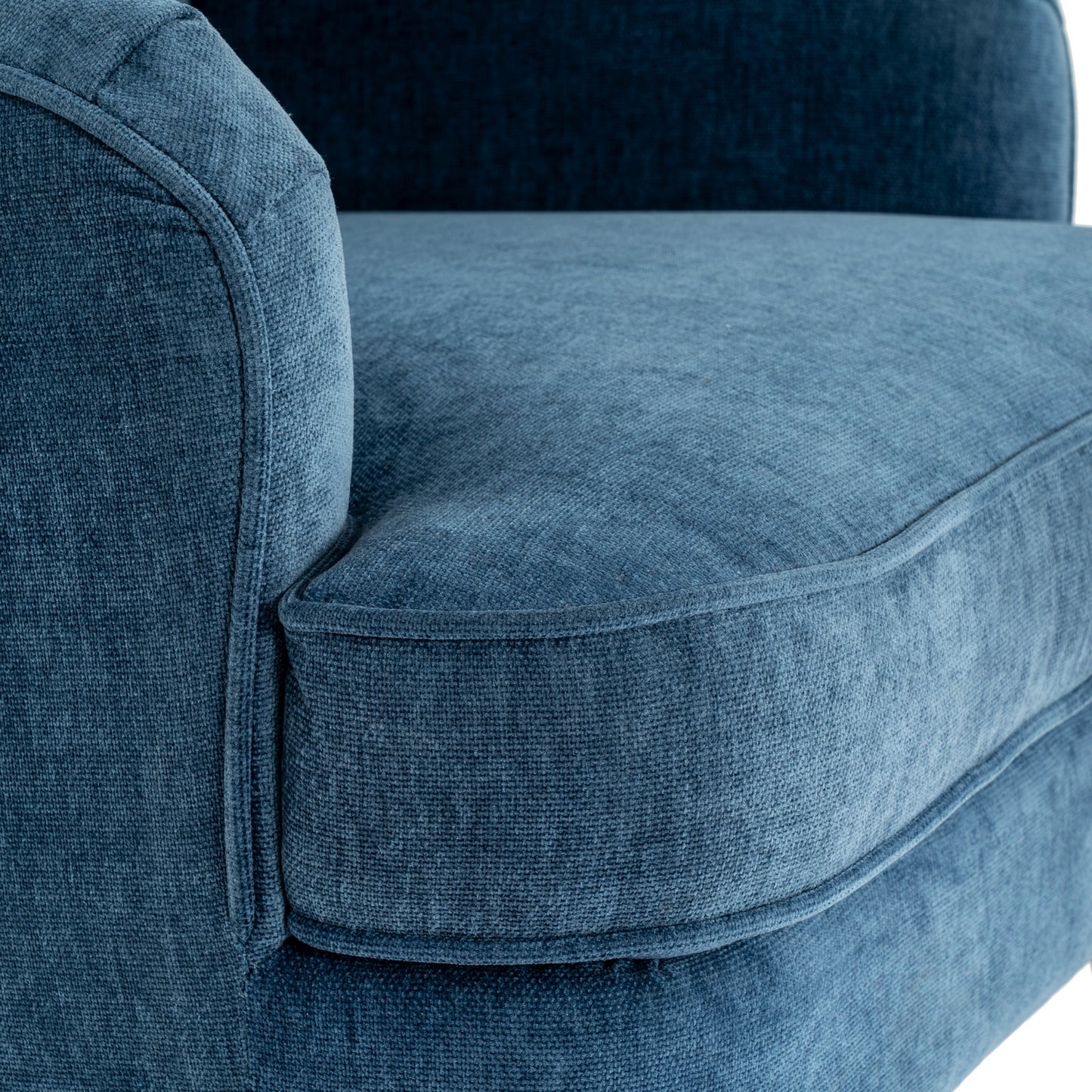 Close-up of a blue upholstered chair with a textured fabric.