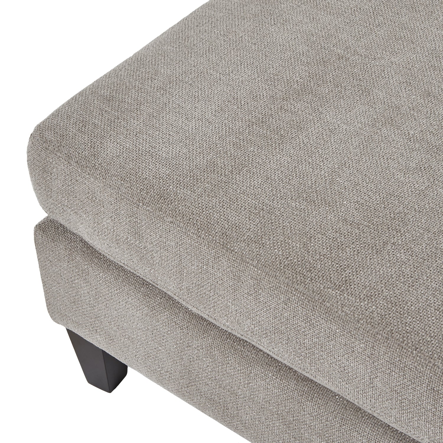 Gray upholstered ottoman with a textured surface on a white background