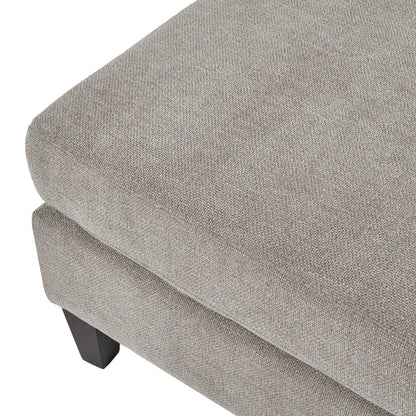 Gray upholstered ottoman with a textured surface on a white background