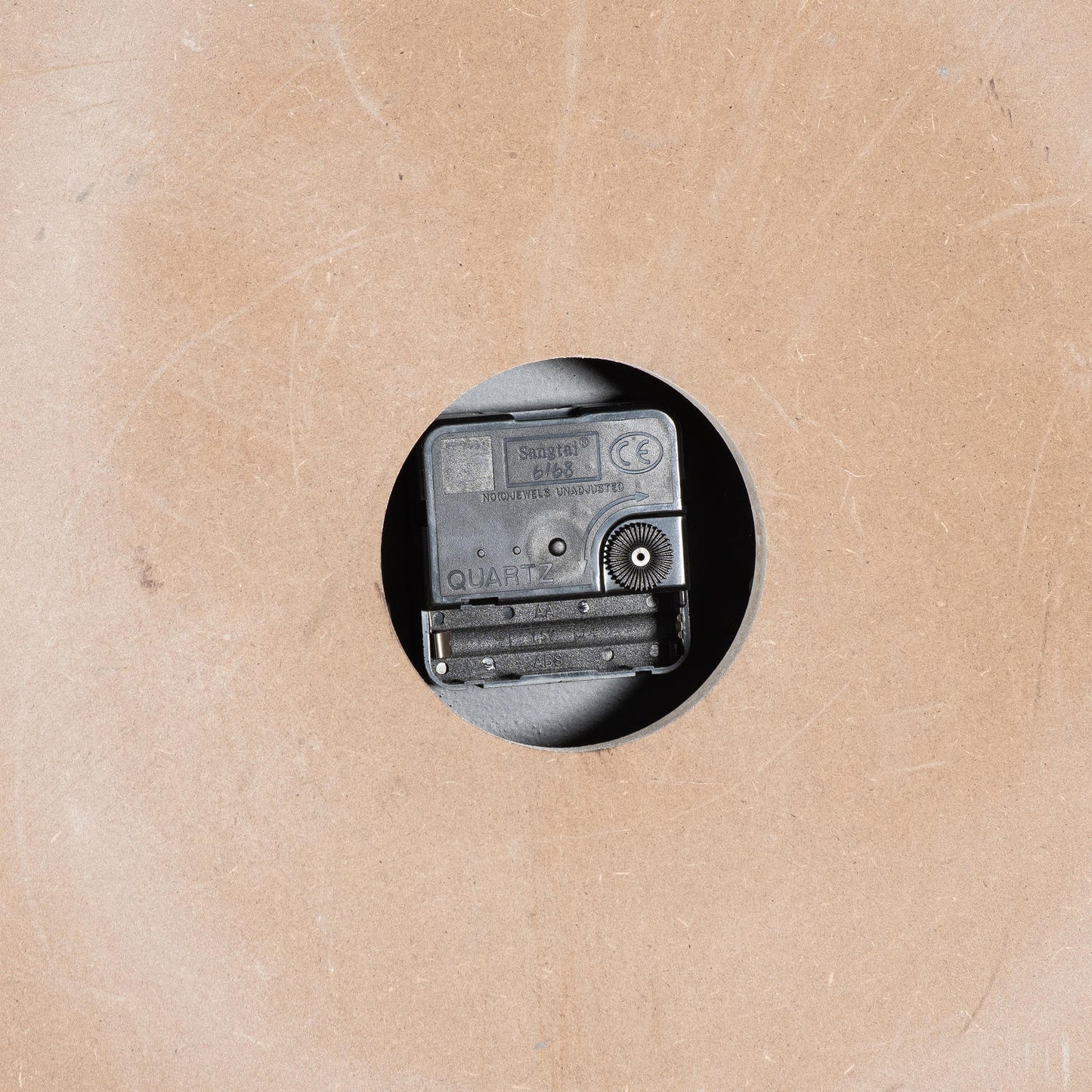 Small vintage camera on a textured beige background