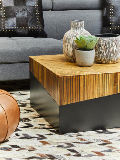 Wooden coffee table with decorative items in a living room setting