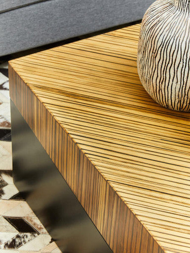 Wooden surface with a zebra-patterned object on a blurred background