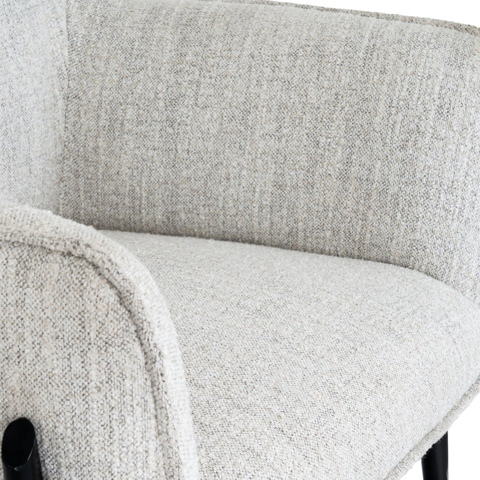 Close-up of a textured gray chair with a blurred background