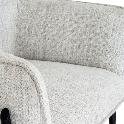 Close-up of a textured gray chair with a blurred background