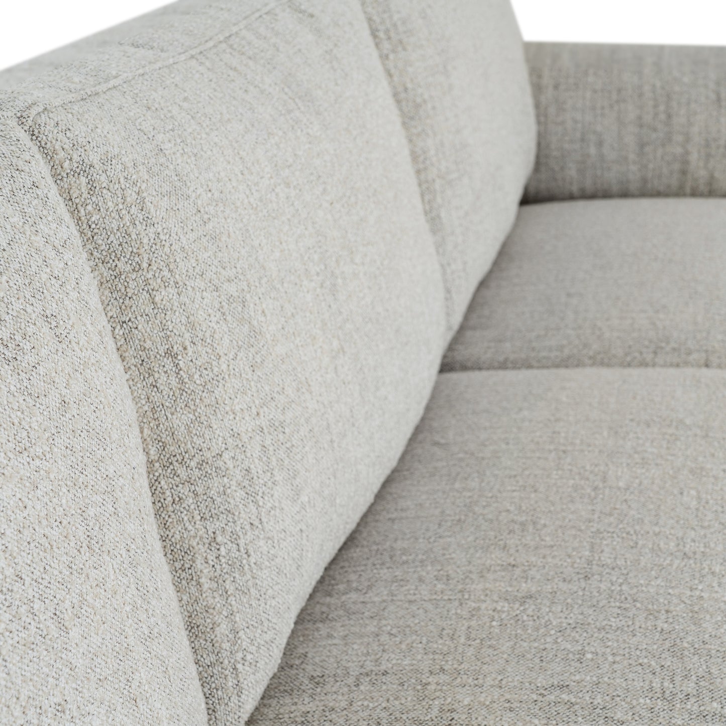 Close-up of a textured gray sofa with a focus on the fabric pattern.