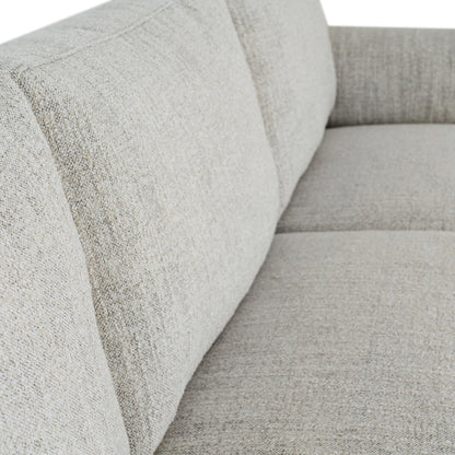 Close-up of a textured gray sofa with a focus on the fabric pattern.