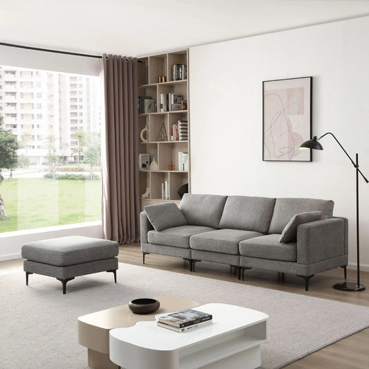 Modern living room with gray sectional sofa, ottoman, and coffee table.