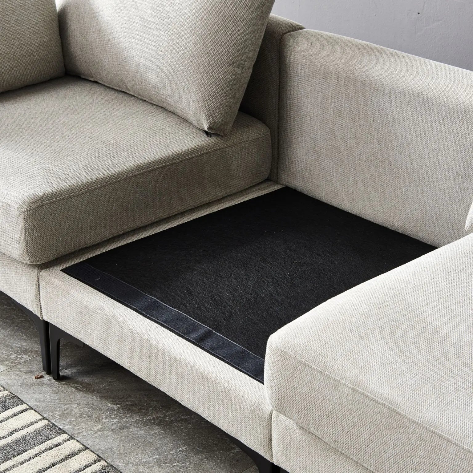 Beige sectional sofa with a pull-out bed mechanism.