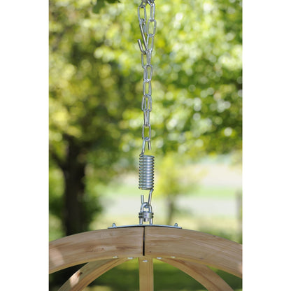 Wooden swing with metal chain and spring against a blurred green outdoor background