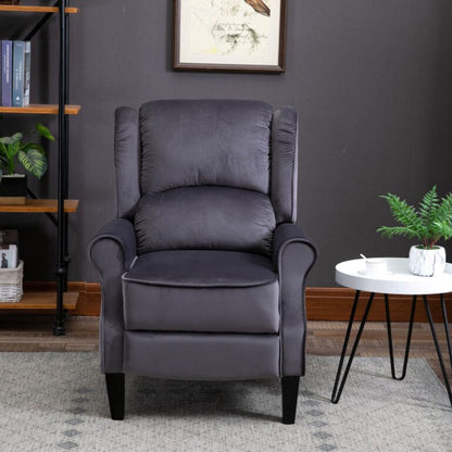 Gray armchair in a living room setting with a bookshelf and table in the background.