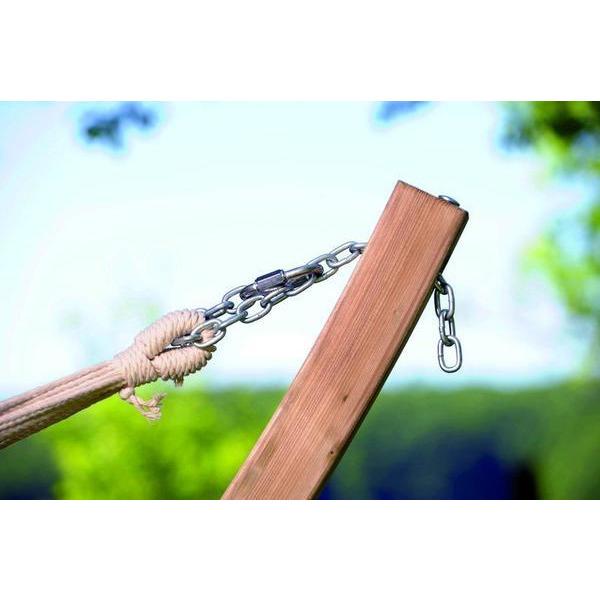 Wooden swing with chain attachment against a blurred green and blue background