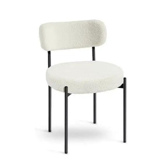 White upholstered chair with black legs on a white background