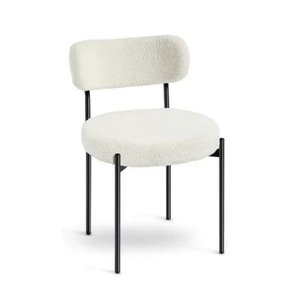White upholstered chair with black legs on a white background