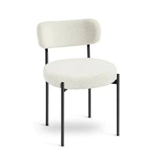 White upholstered chair with black legs on a white background